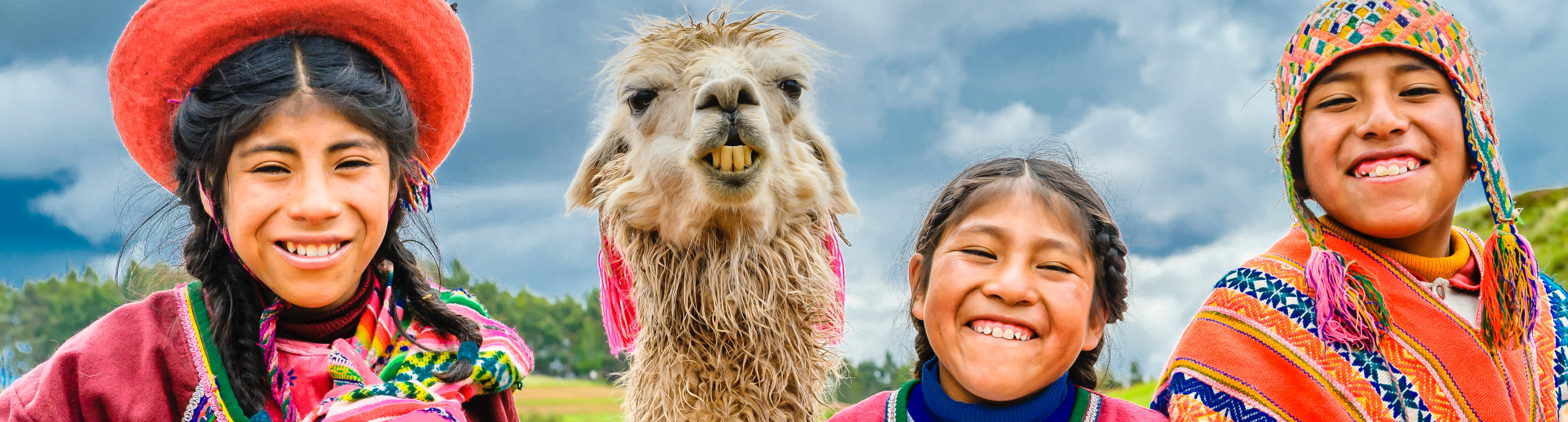 Kids in traditional Peruvian Clothing with a Llama