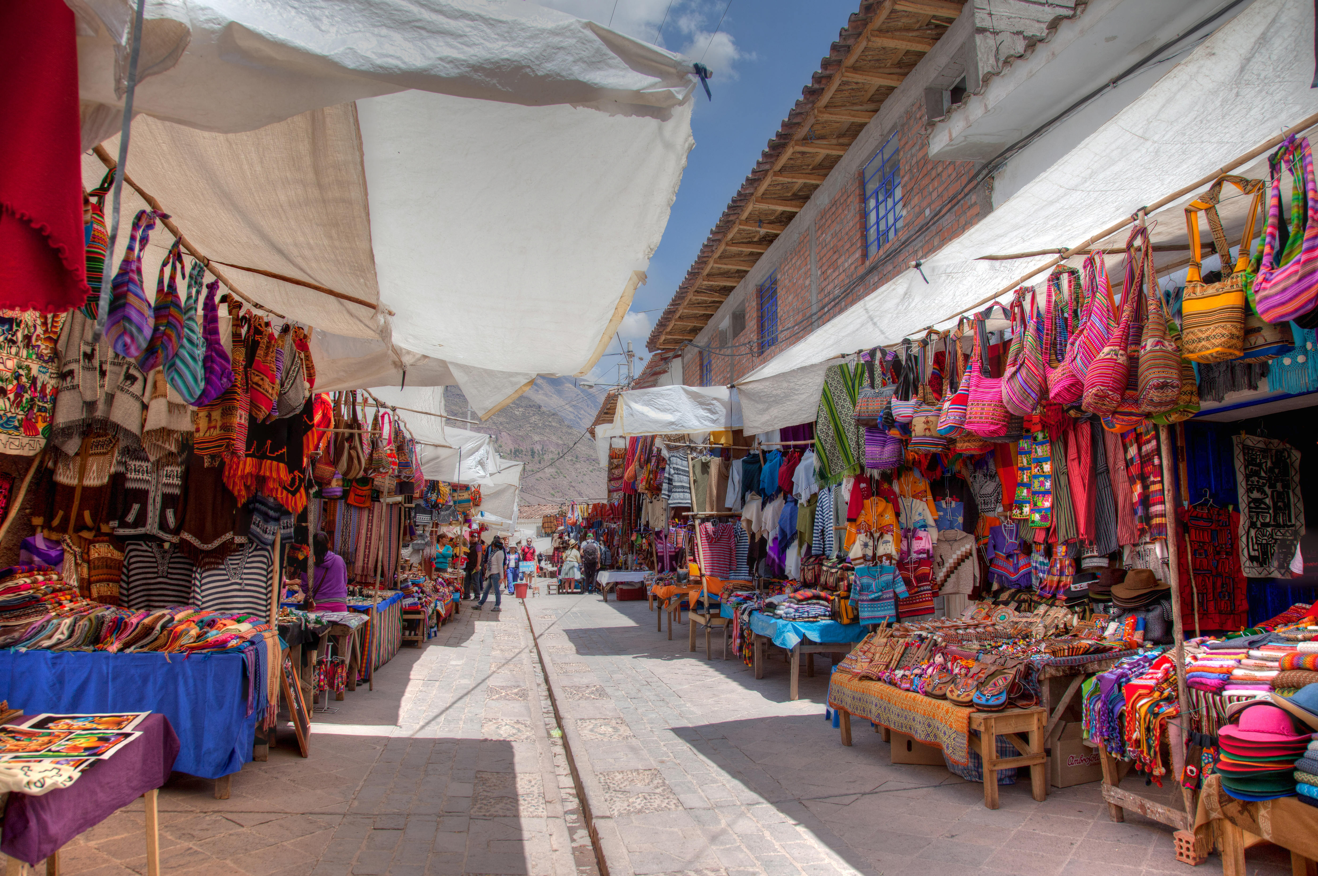 An aisleway lines with booths selling Peruvian souvenirs